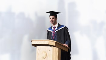 Kishan Parshota receiving an award at a lecturn