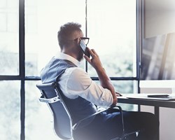 Gentleman on business call at desk