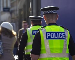 Policemen walking down high-street 