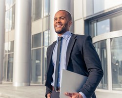 Man in suit walking out of corporate building