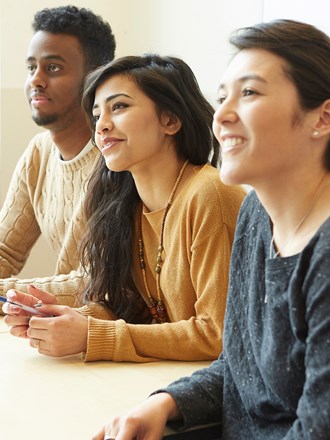 A group of smiling students smiling in a lecture