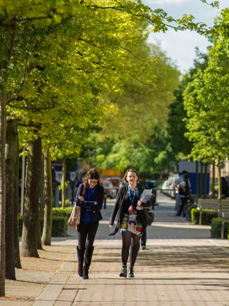 Students walking around the sunny campus of Liverpool University