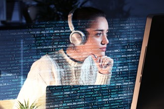 Student studying with headphones at a computer