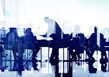 Business professionals at a meeting by a large window