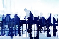 Business professionals at a meeting by a large window