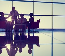 Business professionals at a meeting by a large window