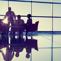 Business professionals at a meeting by a large window