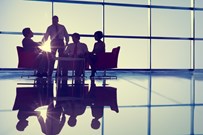 Business professionals at a meeting by a large window