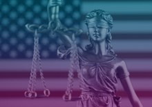 Scales of justice in front of US flag