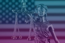 Scales of justice in front of US flag