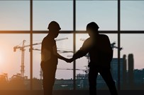 Two builders shaking hands