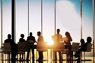 Business professionals in a meeting by a large window