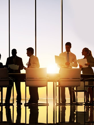 Business professionals in a meeting by a large window