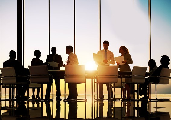 Business professionals in a meeting by a large window