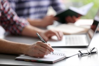 Person writing on a notepad