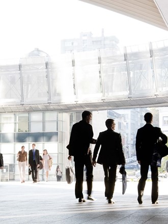 Business professionals walking around modern office space