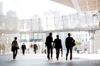 Business professionals walking around modern office space