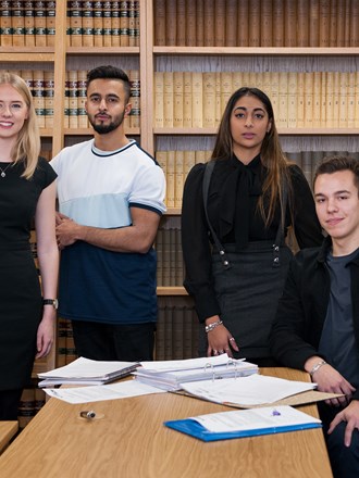 Students infront of bookshelves