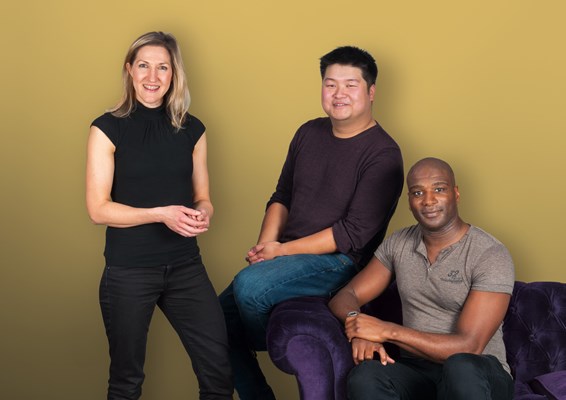 Tutor and students sitting on a sofa